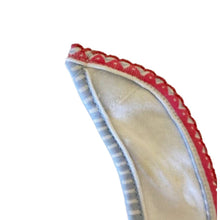 Close-up of a fabric baby bib velcro product with red, blue and white patterned edge - kreassions.com