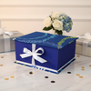 Custom blue gift box on marble surface with gold confetti and flowers, perfect for any celebration – Kreassions